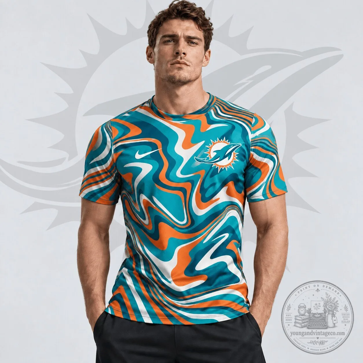 Miami Dolphins NFL Team Crest Abstract Wave All Over Print T-Shirt 1 Miami Dolphins NFL Team Crest Abstract Wave All Over Print T-Shirt